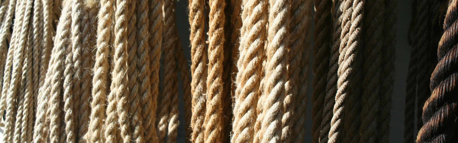 Reb – fint lagt i løkker – hænger ned fra loftet. Rebene varierer lidt i tykkelse og farve. Farverne varierer fra mørkebrun til lys beige.